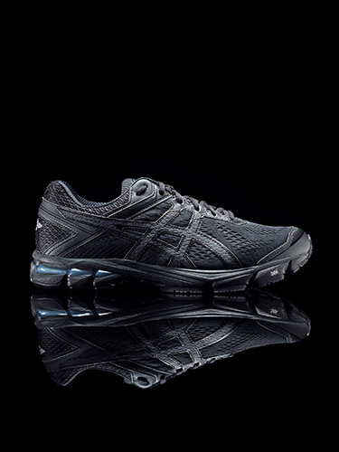 A sleek black running shoe with a modern design, featuring a textured upper and a reflective sole, set against a black background with a mirrored reflection below.